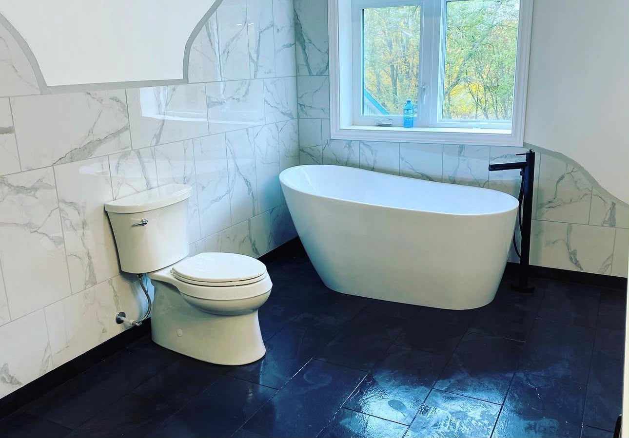 Freestanding oval soaker tub installation with marble wall tile, Eastdale, Oshawa
